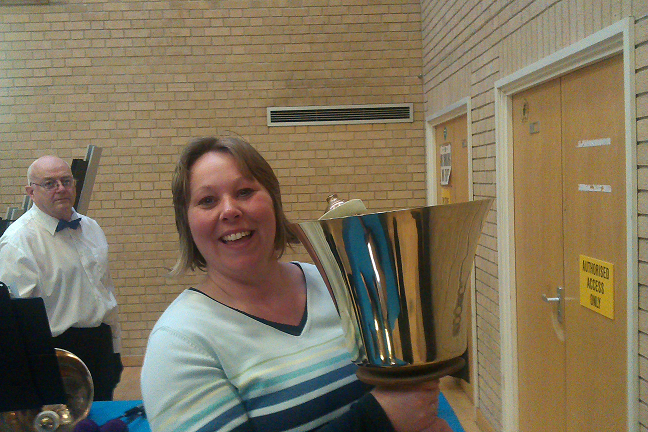 Picture of Amanda holding the largest handbell